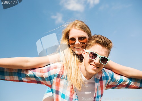 Image of smiling couple having fun outdoors