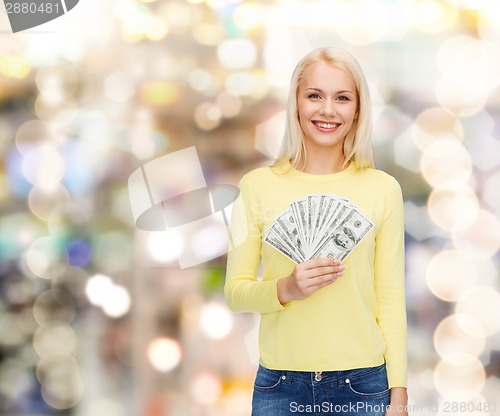 Image of smiling girl with dollar cash money