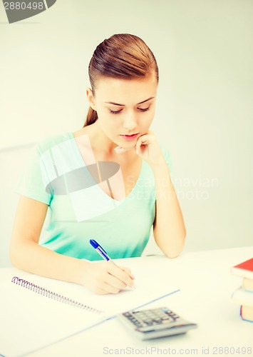 Image of student girl with notebook and calculator