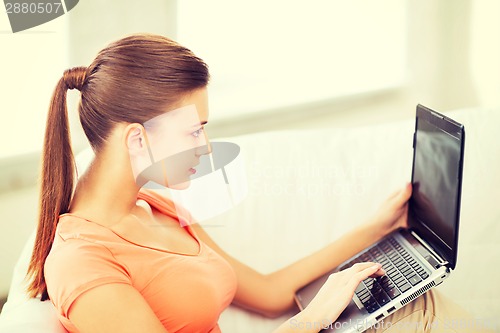 Image of woman using laptop at home