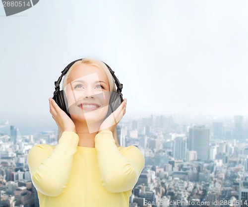 Image of smiling young woman with headphones