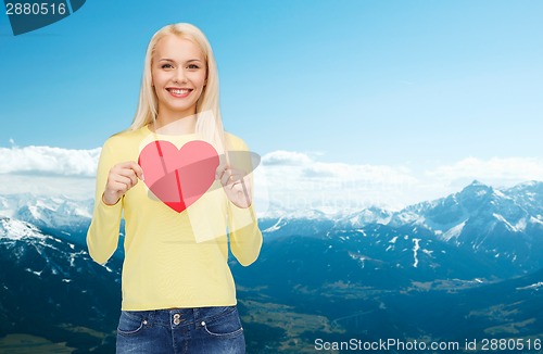 Image of smiling woman with red heart