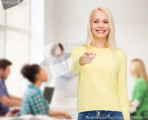 Image of smiling woman pointing finger at you