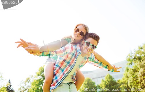 Image of smiling couple having fun in park