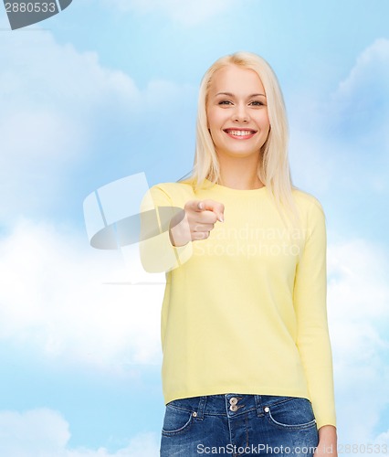 Image of smiling woman pointing finger at you