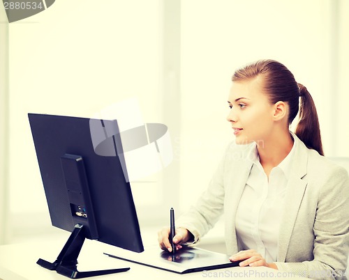 Image of businesswoman with drawing tablet in office