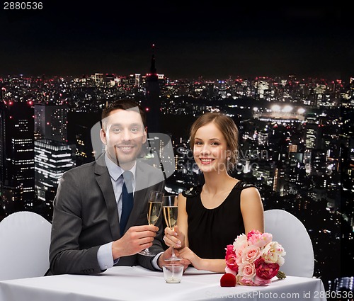 Image of couple with glasses of champagne at restaurant