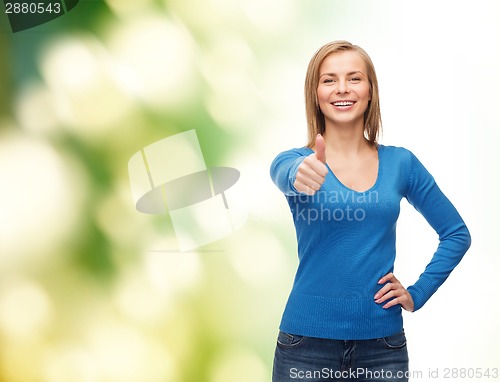 Image of smiling girl in casual clothes showing thumbs up