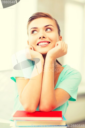 Image of happy smiling student girl with books