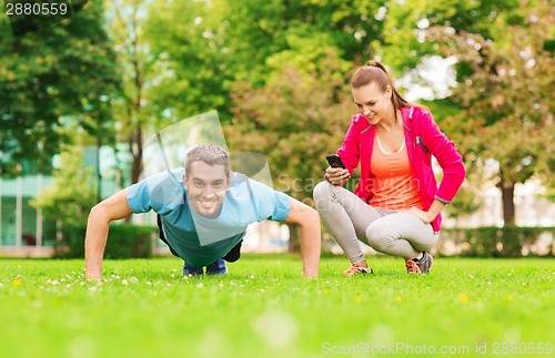 Image of smiling man doing exercise outdoors