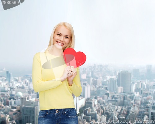 Image of smiling woman with red heart