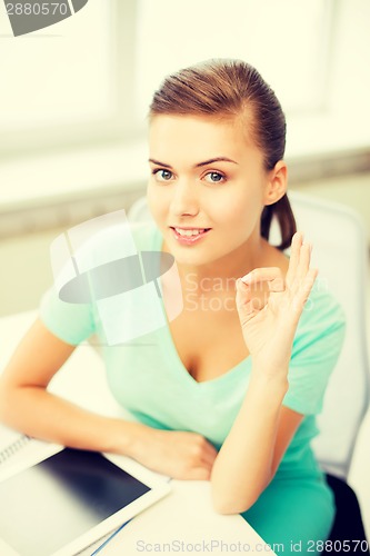 Image of girl with tablet pc showing ok gesture