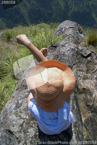 Image of Woman on top of rock