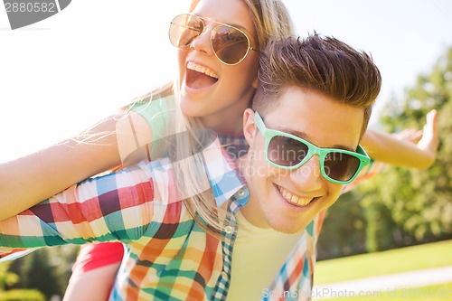 Image of smiling couple having fun in park