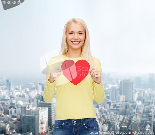 Image of smiling woman with red heart