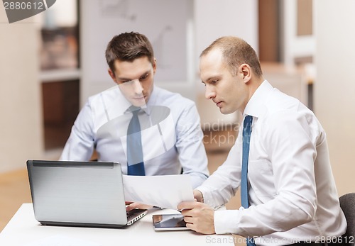 Image of two businessmen having discussion in office