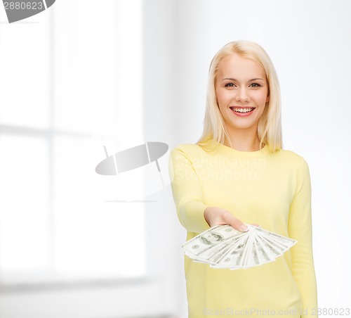 Image of smiling girl with dollar cash money