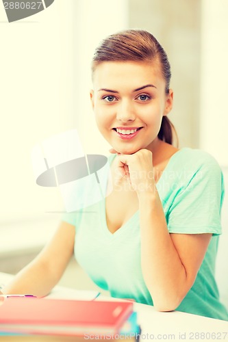 Image of happy smiling student girl with books