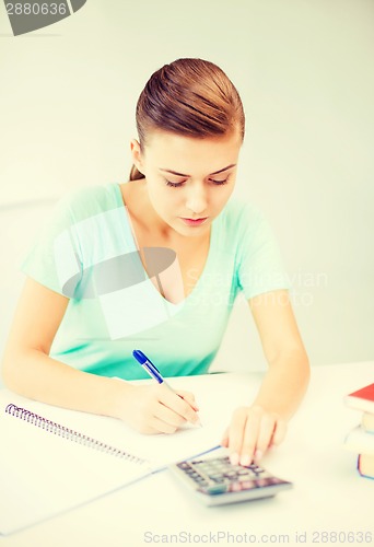 Image of student girl with notebook and calculator