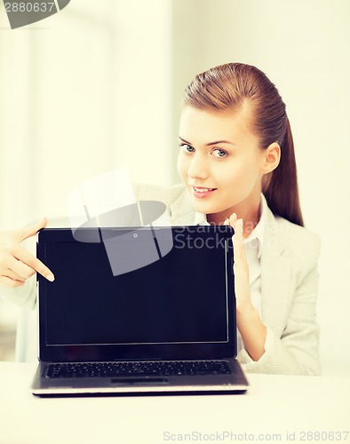 Image of businesswoman with laptop in office