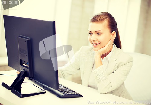 Image of businesswoman with computer in office