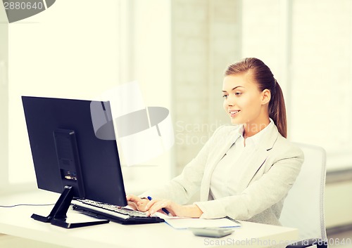 Image of businesswoman with computer in office