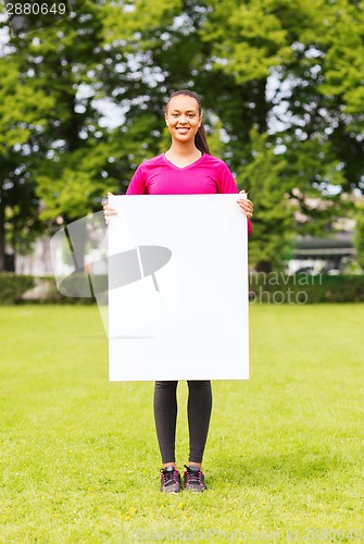 Image of smiling teenage girl with blank white board