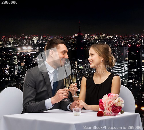 Image of couple with glasses of champagne at restaurant