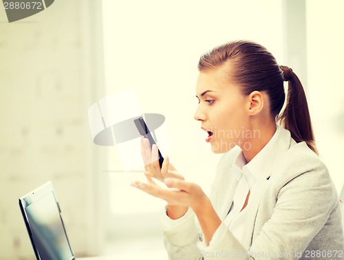 Image of woman shouting into smartphone