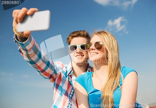 Image of smiling couple having fun outdoors