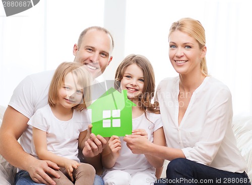 Image of smiling parents and two little girls at new home
