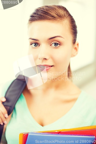 Image of student girl with school bag and color folders
