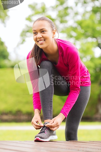 Image of smiling woman exercising outdoors