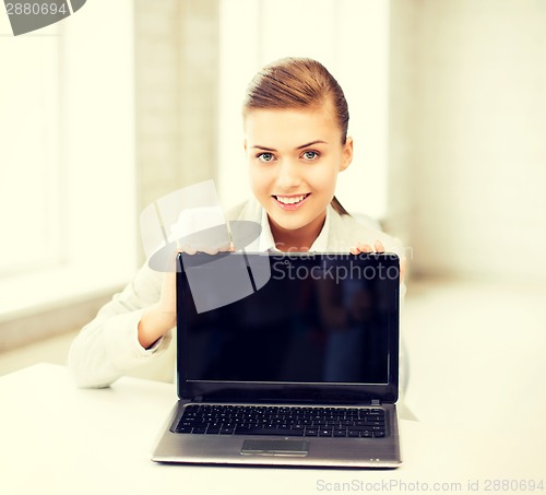 Image of businesswoman with laptop in office