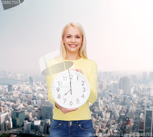 Image of student with wall clock