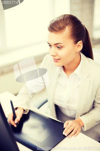Image of businesswoman with drawing tablet in office