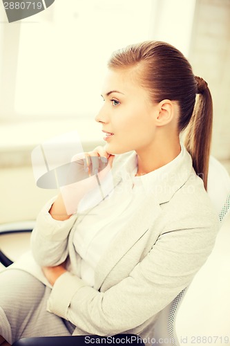 Image of pensive woman in office
