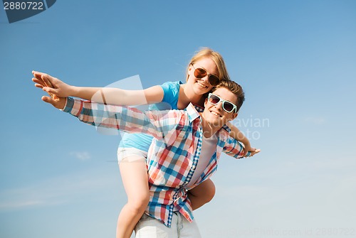 Image of smiling couple having fun outdoors