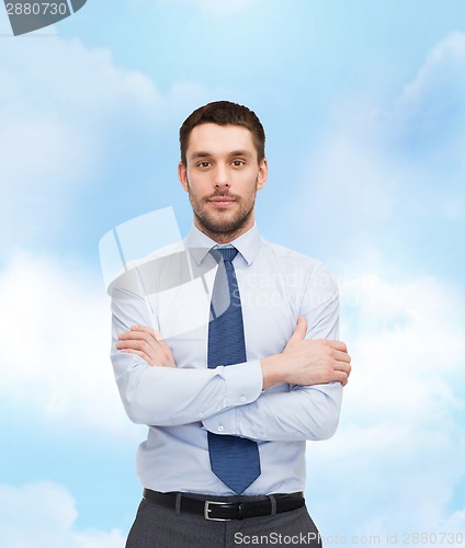 Image of handsome businessman with crossed arms