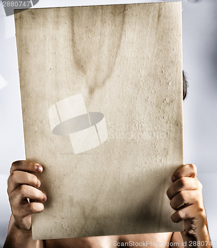 Image of Plywood sign held up by young hands