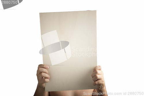 Image of Plywood sign held up by young hands