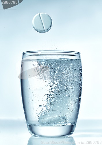 Image of tablet falling into glass