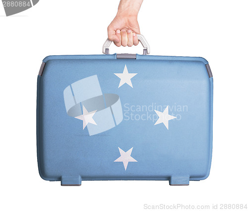 Image of Used plastic suitcase with stains and scratches