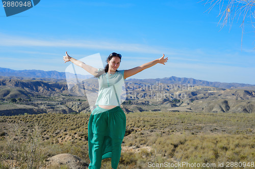 Image of Happy woman open arms stand at mountain