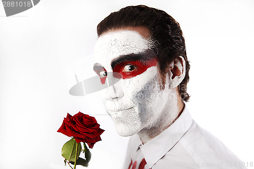 Image of Man with white mascara and red rose