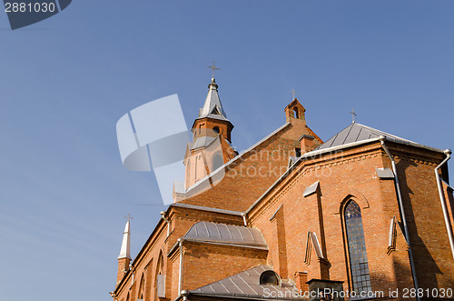 Image of gothic church tower crosses on blue sky background 