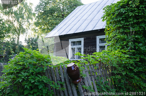 Image of old country house with windows and fence clay jug 