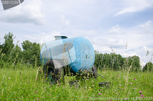 Image of Blue water cistern drink for animal between grass 