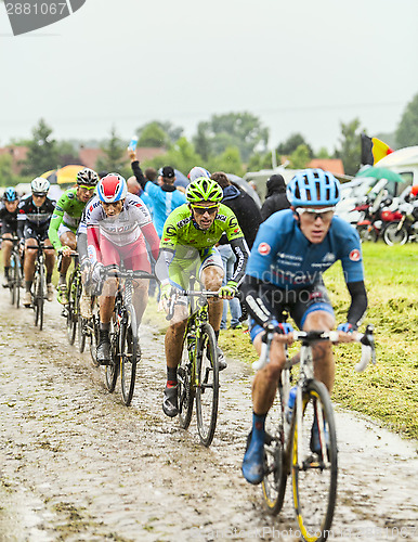 Image of The Peloton on a Cobbled Road- Tour de France 2014