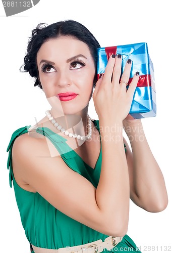 Image of Attractive woman listens sounds from box